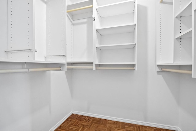 walk in closet featuring dark parquet floors