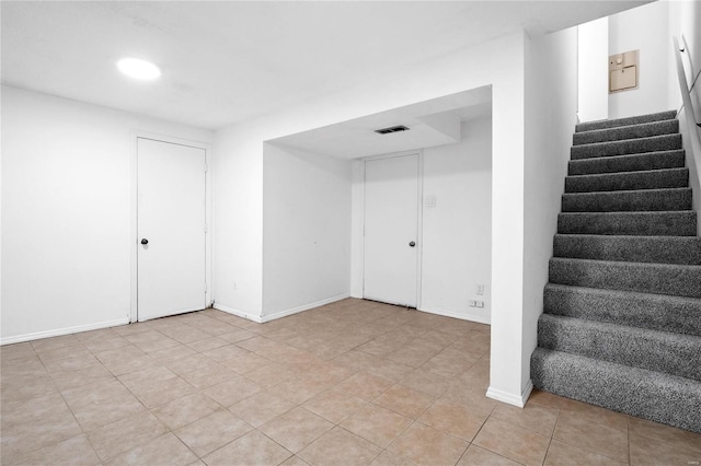 basement featuring light tile patterned floors