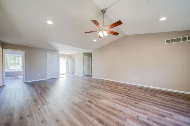 spare room with light hardwood / wood-style floors, vaulted ceiling, and ceiling fan