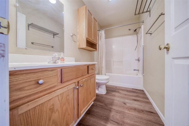 full bathroom featuring toilet, vanity, wood-type flooring, and shower / tub combo