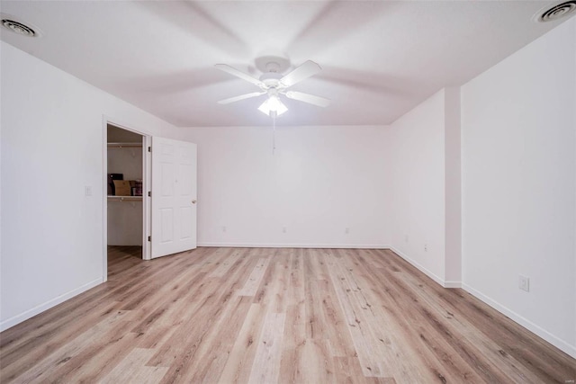 spare room featuring light hardwood / wood-style flooring and ceiling fan