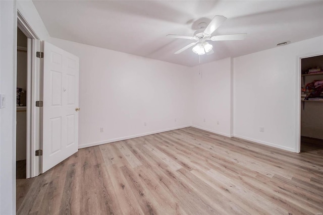 empty room with light hardwood / wood-style flooring and ceiling fan