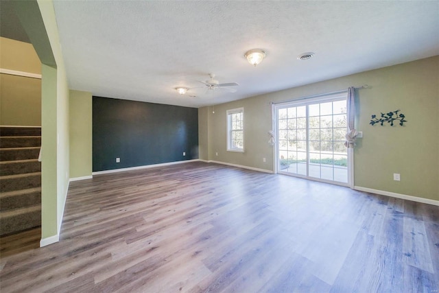 unfurnished room featuring a textured ceiling, wood-type flooring, and ceiling fan