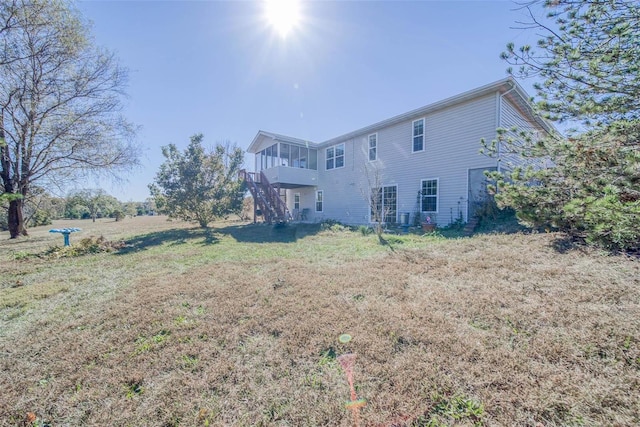 rear view of property featuring a lawn