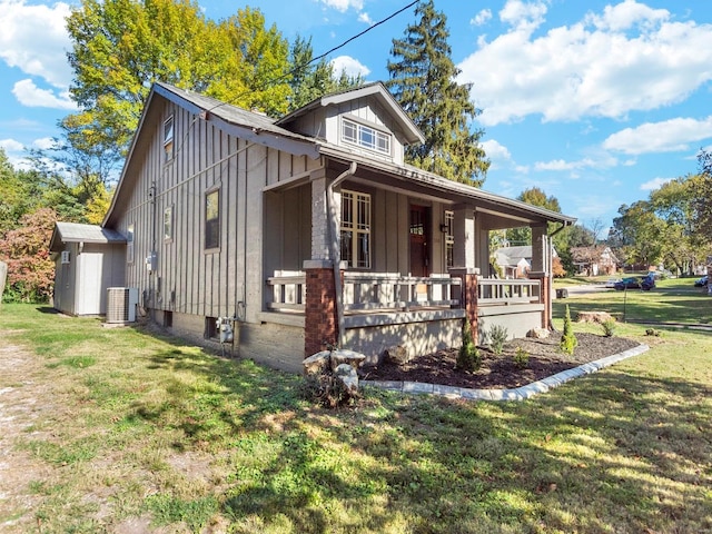 exterior space with a porch, a front lawn, and central air condition unit