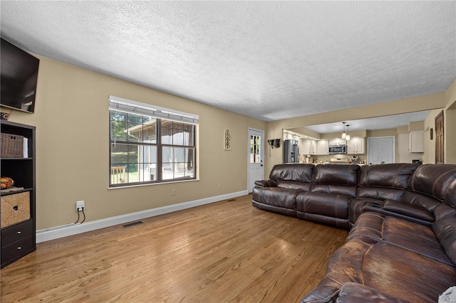 living room featuring hardwood / wood-style flooring and a textured ceiling