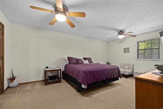 carpeted bedroom with ceiling fan and a textured ceiling