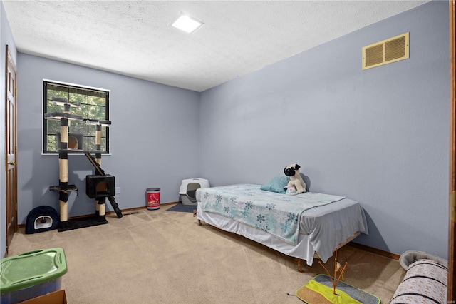 carpeted bedroom featuring a textured ceiling