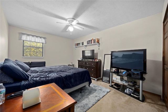 carpeted bedroom featuring ceiling fan and a textured ceiling