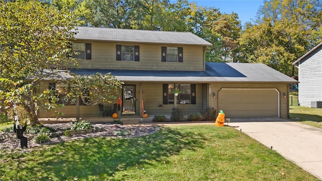 view of front of home with a front yard, a garage, and a porch