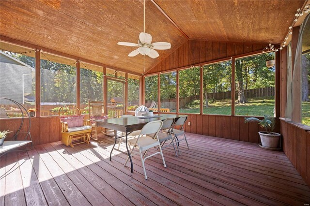 sunroom with ceiling fan, vaulted ceiling, and wood ceiling