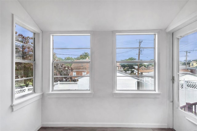 unfurnished sunroom with lofted ceiling