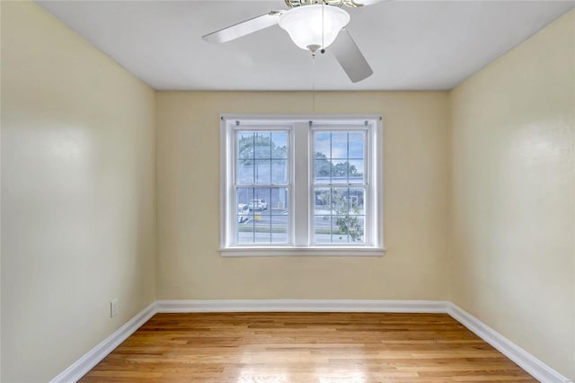 spare room with light hardwood / wood-style flooring and ceiling fan