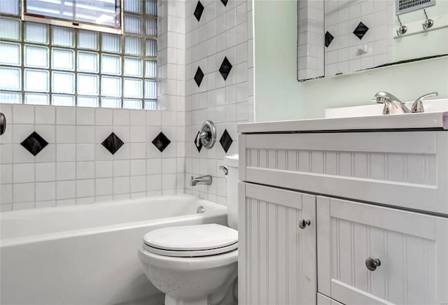 full bathroom with toilet, tiled shower / bath, and vanity