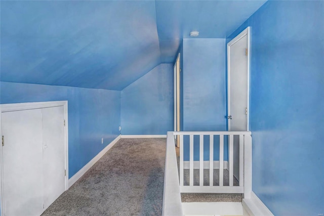 additional living space featuring lofted ceiling and carpet flooring