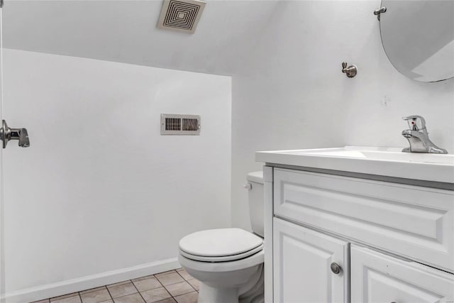 bathroom featuring vanity, toilet, and tile patterned floors