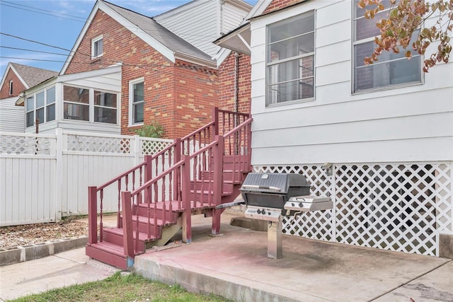 view of exterior entry with a patio area