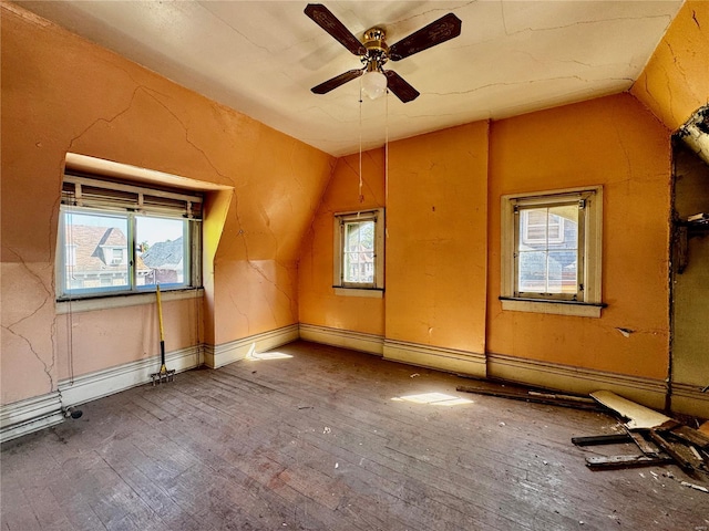 bonus room featuring ceiling fan, hardwood / wood-style flooring, lofted ceiling, and a healthy amount of sunlight