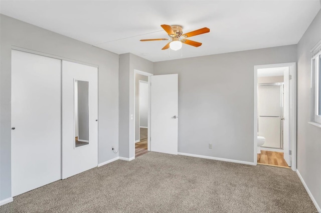 unfurnished bedroom with carpet, ensuite bathroom, a closet, and ceiling fan