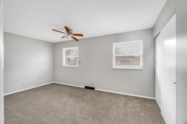 carpeted empty room with ceiling fan