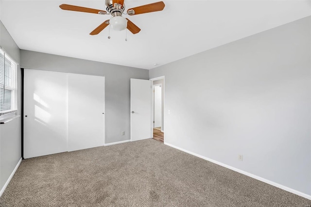 unfurnished bedroom with carpet, a closet, and ceiling fan