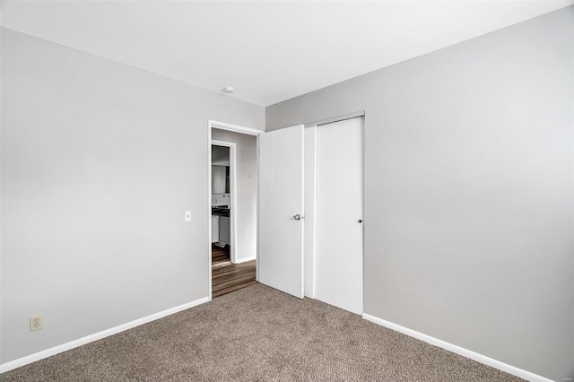 unfurnished bedroom with carpet and a closet