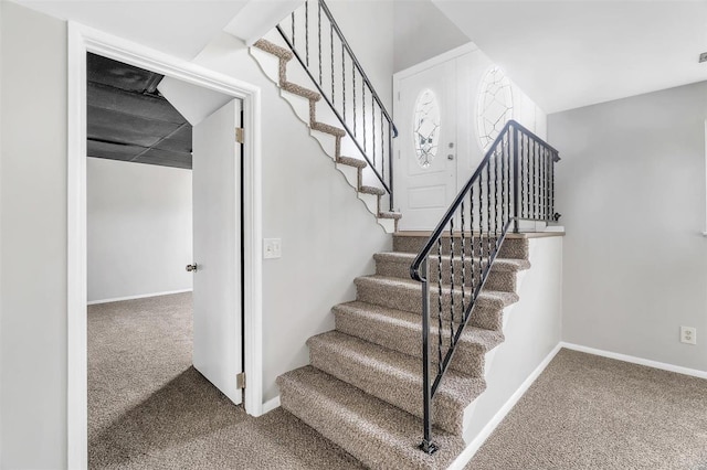 stairway featuring carpet flooring