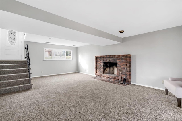 unfurnished living room featuring carpet floors and a brick fireplace