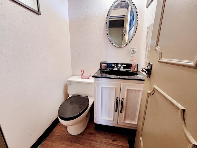 bathroom featuring hardwood / wood-style floors, vanity, and toilet