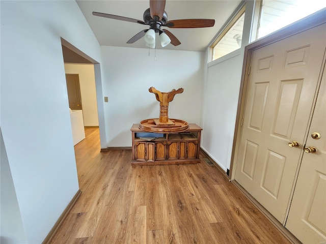 hall featuring light hardwood / wood-style floors and lofted ceiling