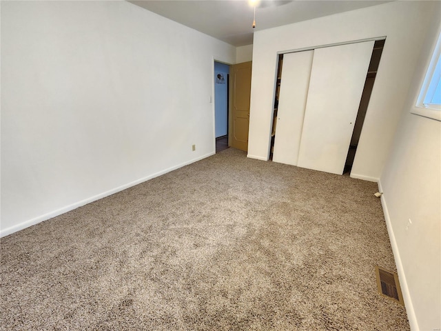 unfurnished bedroom with carpet flooring and a closet