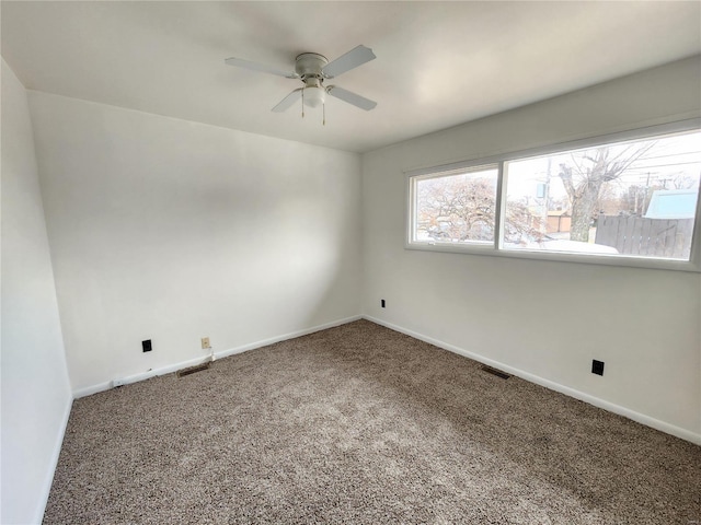 empty room featuring carpet and ceiling fan