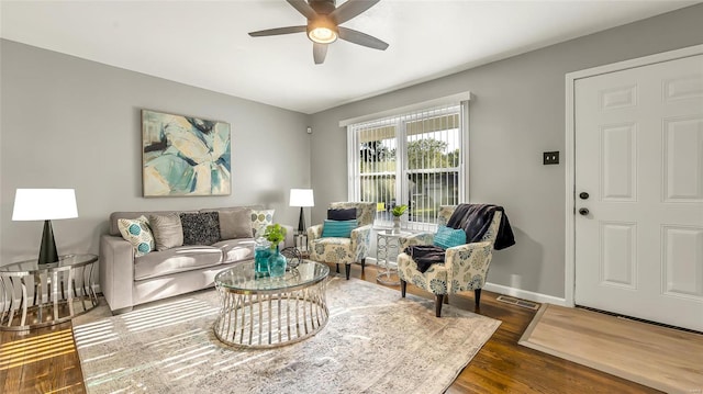 living room with dark wood-type flooring and ceiling fan