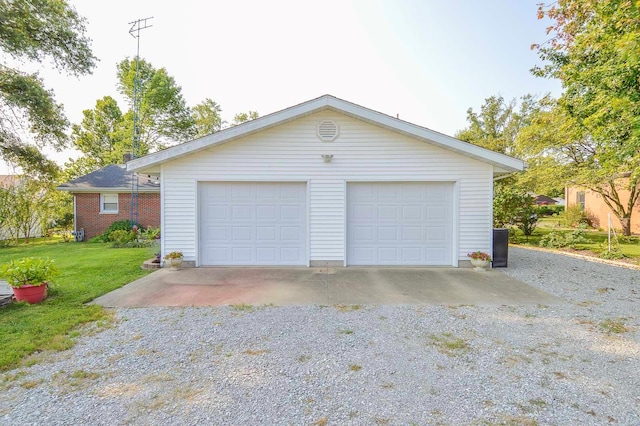 garage featuring a lawn