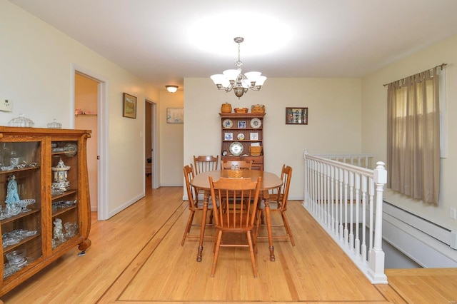 dining room featuring an inviting chandelier and light hardwood / wood-style flooring