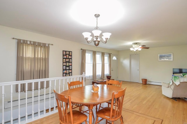 dining space featuring a baseboard radiator, ceiling fan with notable chandelier, and light hardwood / wood-style floors