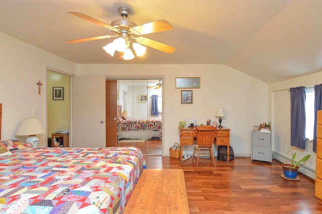 bedroom featuring ceiling fan, baseboard heating, hardwood / wood-style flooring, a closet, and vaulted ceiling