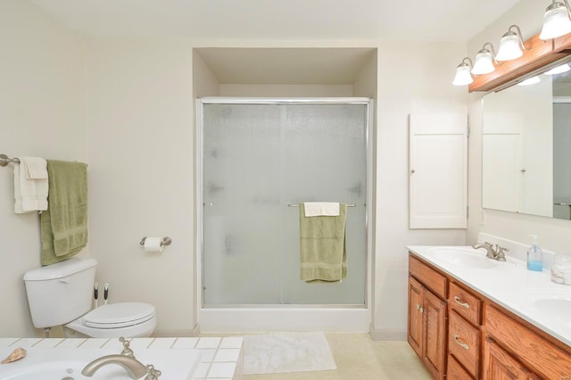 bathroom featuring vanity, toilet, and a shower with door