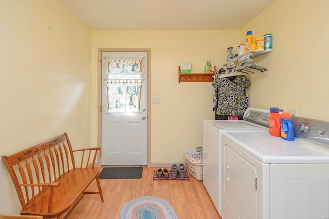 washroom featuring washer and clothes dryer and light hardwood / wood-style flooring