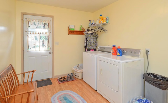 washroom featuring light hardwood / wood-style floors and washing machine and clothes dryer