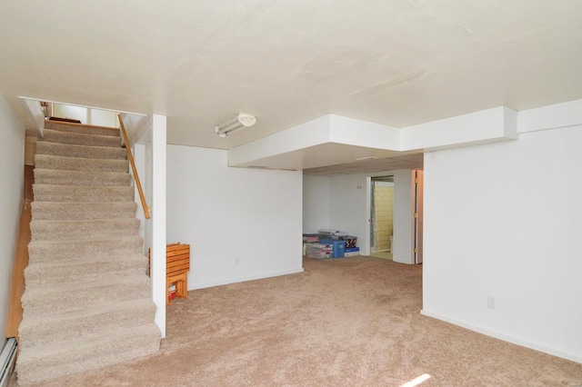 basement with a baseboard radiator and carpet flooring