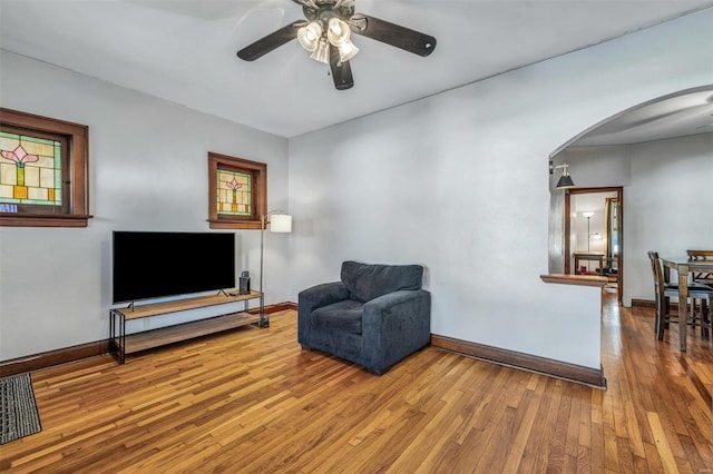 living area with ceiling fan and wood-type flooring