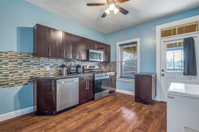 kitchen featuring dark hardwood / wood-style floors, a healthy amount of sunlight, backsplash, and appliances with stainless steel finishes