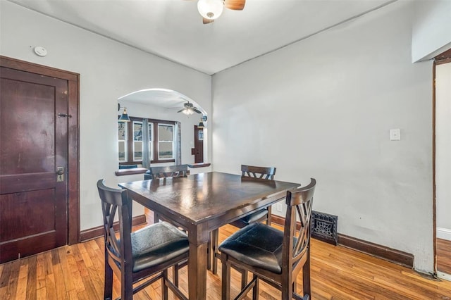 dining space with light wood-type flooring and ceiling fan