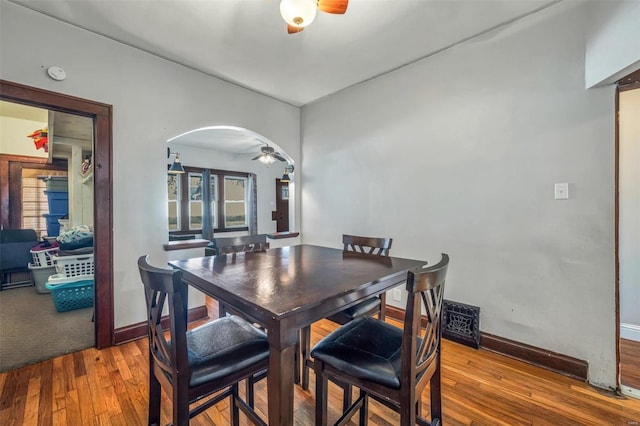 dining space with ceiling fan and hardwood / wood-style flooring