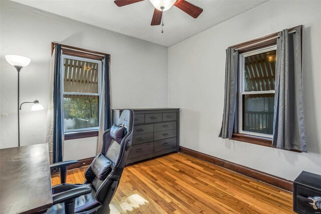 home office with hardwood / wood-style flooring and ceiling fan