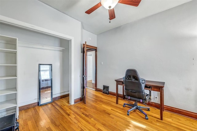 home office featuring light hardwood / wood-style flooring and ceiling fan