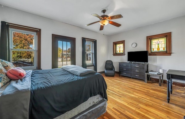 bedroom with ceiling fan and light hardwood / wood-style flooring