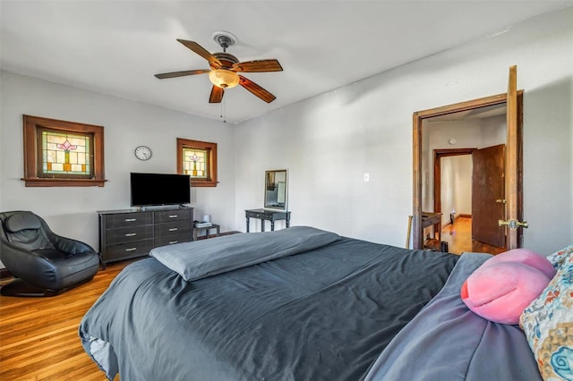 bedroom with ceiling fan and light hardwood / wood-style floors