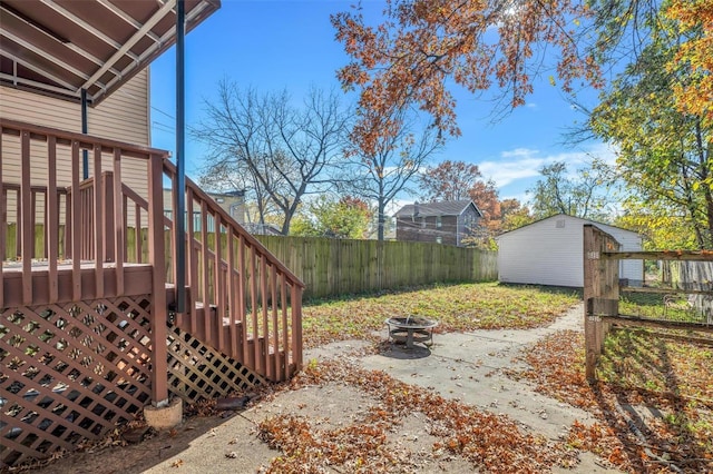 view of yard featuring a fire pit and an outdoor structure